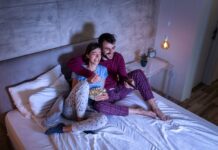 Couple watching TV in bed