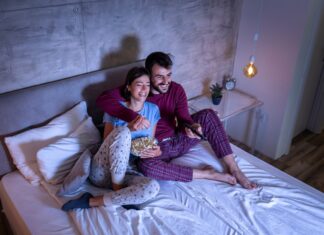 Couple watching TV in bed